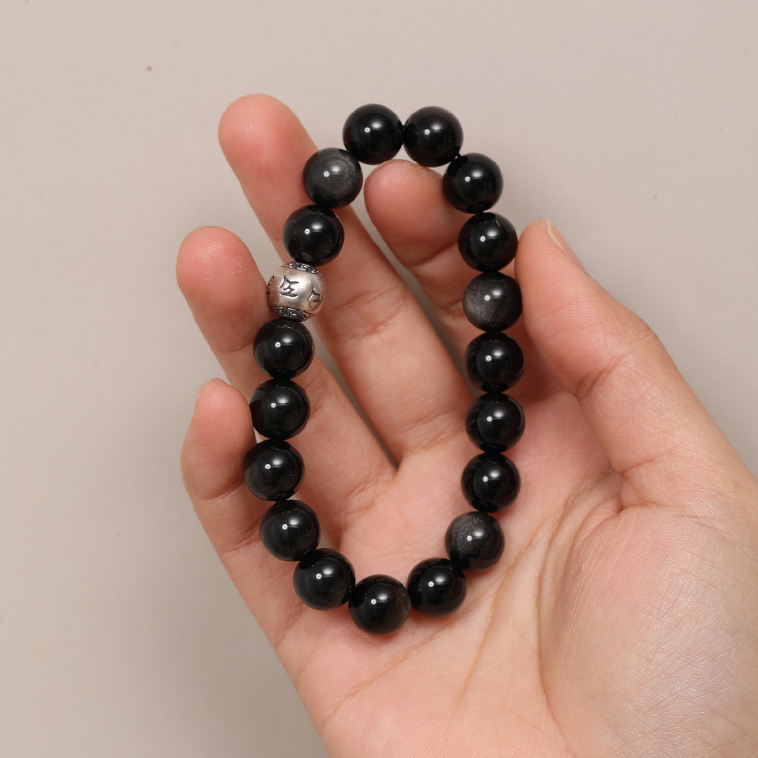 This silver obsidian bracelet allows you to bring your own protective barrier