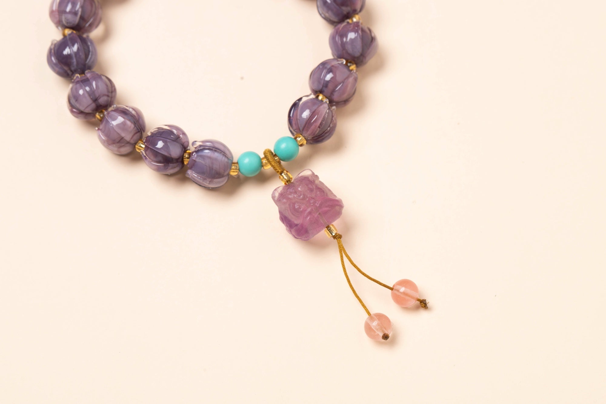 I braccialetti in vetro smaltato viola raffigurano un fiore di loto che simboleggia la "buona fortuna" ed è pieno di energia positiva.